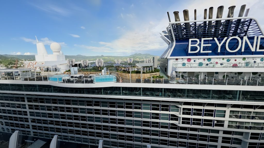 The Rooftop Garden and cantilevered float pools onboard Celebrity Beyond docked in Puerto Plata, Dominican Republic.