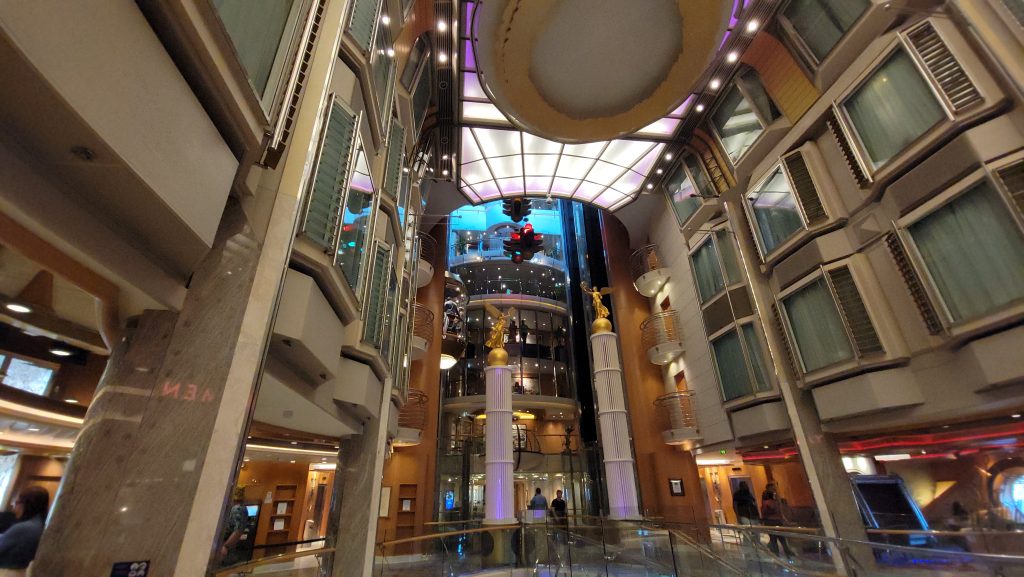 A dramatic low-angle view looking up at multiple tiers of interior promenade view stateroom windows lining the grand atrium inside Freedom of the Seas.